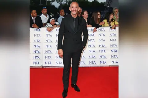 Alan Chapman/Dave Benett/Getty Images Neil Ashton arrives at the National Television Awards 2023 at The O2 Arena, London