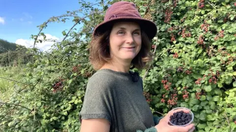 Sarah-Jane Cobley standing next to a bush