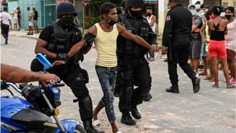 Getty Images A protester being arrested in Cuba