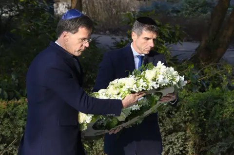AFP Dutch Prime Minister Mark Rutte and State Secretary Paul Blokhuis lay a wreath