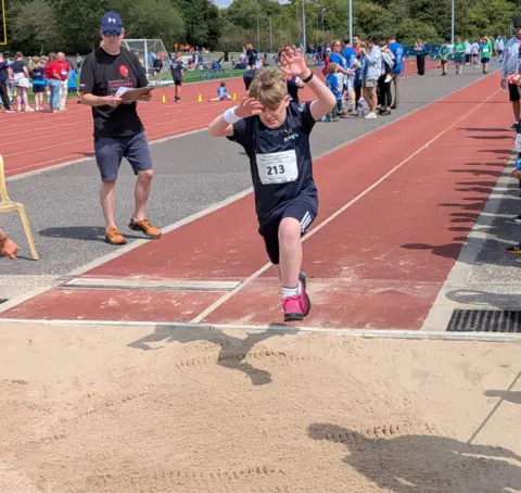 Family handout Milo, from Rutland, competing in the long jump at the British Transplant Games in 2025 in Oxford.