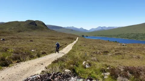 UK Cycling man on bike in scotland