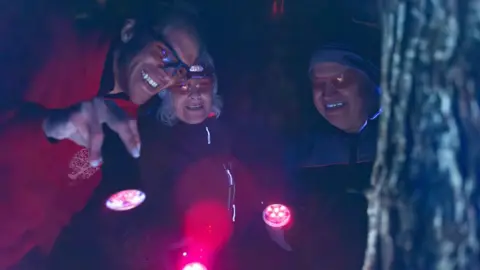 David Atthowe David Atthowe with UV torch and tow other on his a forest tour