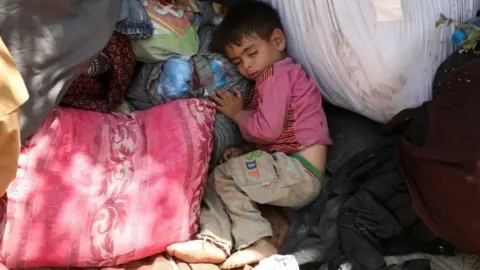 Reuters An internally displaced Afghan child sleeps in a public park in Kabul, Afghanistan. Photo: 10 August 2021