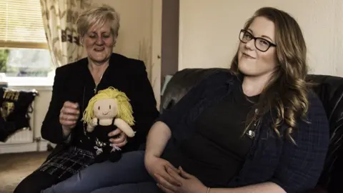Raise The Roof/BBC When Kimberly Benson, aka wrestler Viper, is off fighting abroad, she's cheered on at home in Ayrshire, Scotland, by her biggest fan - her mum Yvonne, who loves to show off her knitted Viper doll