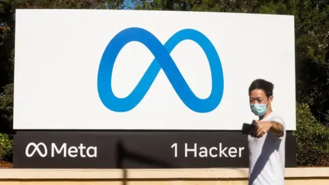 AFP A man takes a selfie in front of a sign for "Meta", the new name for Facebook's parent company, outside Facebook headquarters in Menlo Park on 28 October 2021