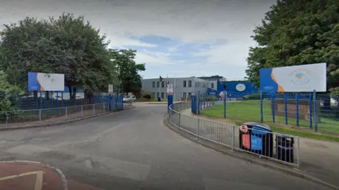 The entrance to Leasowes High School in Halesowen where there blue gates and railings surround the buildings