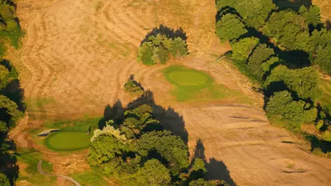 PA Media The dried out greens and fairways of Ashton Court Golf Course, near Bristol, where the prolonged dry conditions, have left the parched land turning from green to brown.