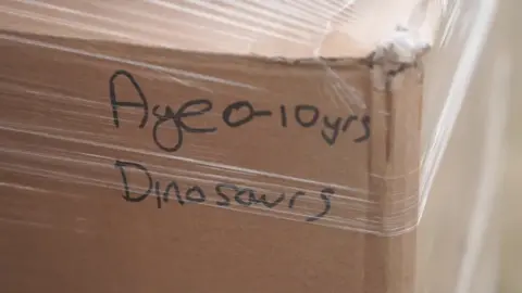 Stephen Huntley/BBC A box labelled dinosaurs