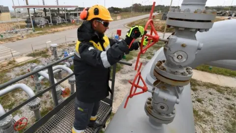 Getty Images An employee works at the Tunisian Sergaz company, that controls the Tunisian segment of the Trans-Mediterranean (Transmed) pipeline, through which natural gas flows from Algeria to Italy, in El-Haouaria, some 100km east of the capital Tunis, on April 14, 2022