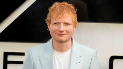 ed sheeran in a pale blue suit