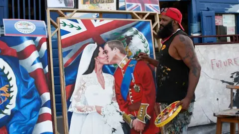 Getty Images Artist Alex Sanker painting a picture of William and Kate in Belize City