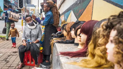 BBC/Shiraaz Mohamed A street hairdresser in Hillbrow, Johannesburg, South Africa