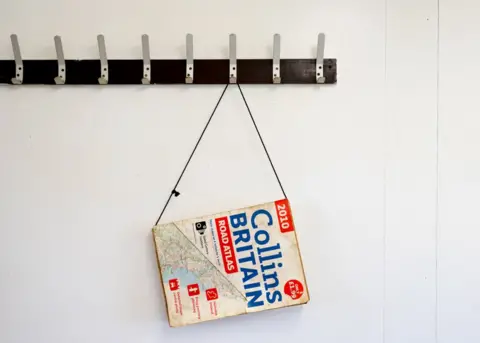 Peter Dench Collins Road Atlas of Britain hans inside BABS cafe. Retford, Nottinghamshire.