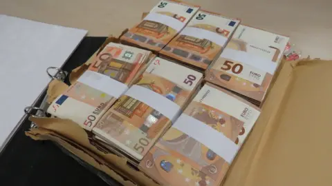 National Crime Agency  A photo of the cash seized from Mark Adams at Belfast International Airport