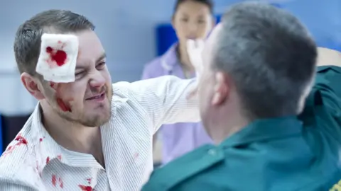 Getty Images Man punching NHS worker