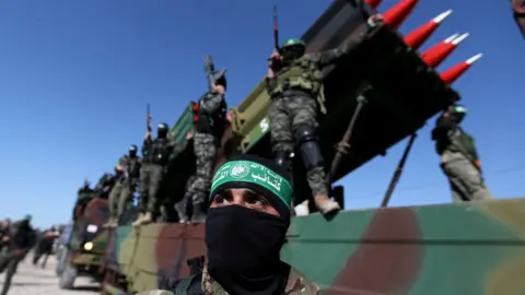 Reuters Hamas militants attend an anti-Israel rally in Khan Younis, in the southern Gaza Strip (27 May 2021)