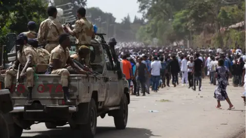 AFP Oromo regional police officers wait near a protest in Bishoftu, Ethiopia (archive shot)