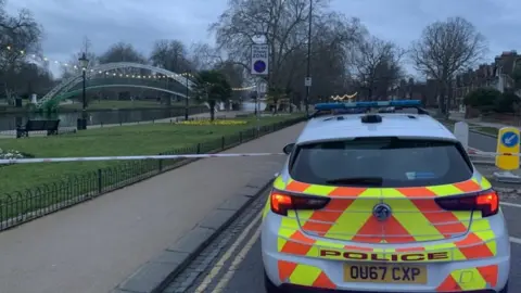 Alex Pope/BBC Police cordon and car in Bedford