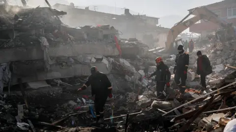 Reuters Rescuers search for survivors, in the aftermath of a deadly earthquake in Hatay, Turkey