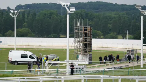 Zac Goodwin Big screen and police at Towcester Racecourse