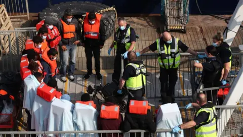 PA Media This group was brought onto the quayside from HMC Seeker