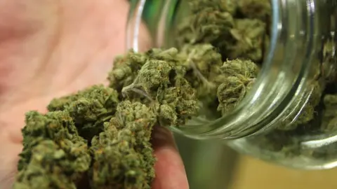 Getty Images A glass jar containing marijuana