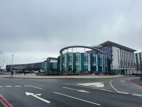 A colourful curved facade on a hospital building's entrance