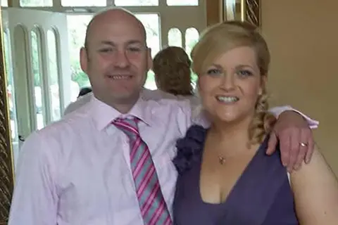 Family photo A woman and man smile at the camera 