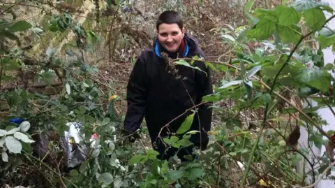 Janine Tanner Janine Tanner, pictured in 2018, standing among weeds and branches on Long Stairs before clearance work began
