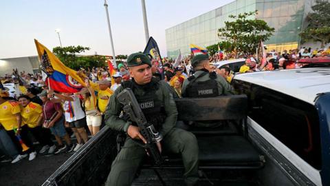 Police officers patrol in Colombia during a campaign rally