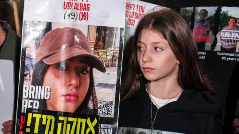 Getty Images poster of israeli hostage Liri Albag with a female relative next to it