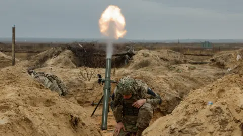 EPA Ukrainian soldiers fire a mortar
