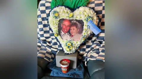 Family Photo A floral tribute in heart shape with a photo in the middle