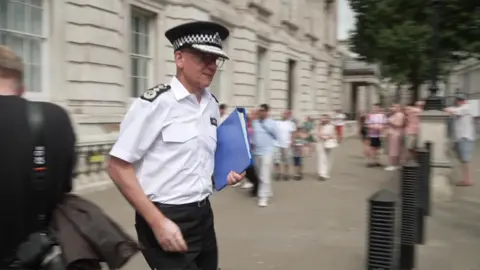 Sir Mark Rowley walks retired  of the Cabinet Office building