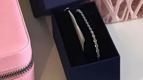 Lisa Bones' stolen bracelet in a black display case