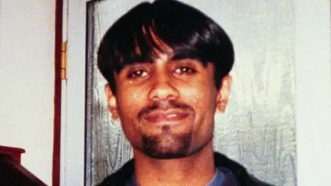 Family handout Man with black hair and moustache, smiling at camera
