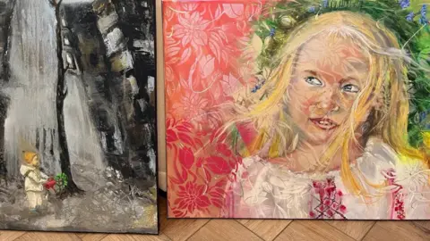 Two of Viktoriya Richardson's paintings - one of an angel-like child watering the green shoots of a tree amongst a bombed out cityscape and another of a young girl with blonde hair in Ukrainian national dress