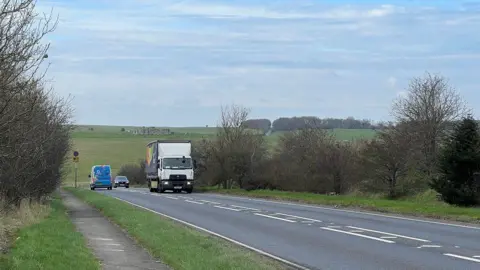 A303 with a lorry, car and van with Stonehenge in the background landscape