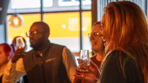 A group of people enjoying cocktails at a bar