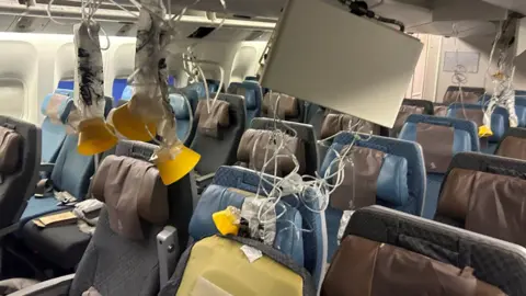 Reuters The interior of a plane with lots of oxygen masks hanging down