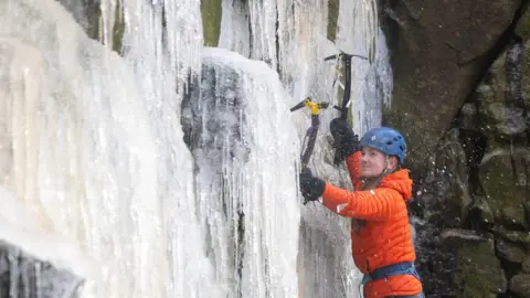 Rod Kirkpatrick/RKP Photography A group of climbers useing specialised equipment to climb the frozen Kinder Downfall waterfall