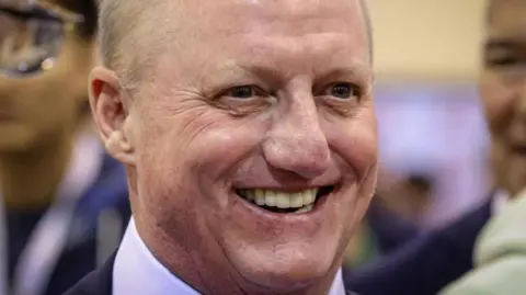 Reuters Greg Abel smiles during an investor meeting