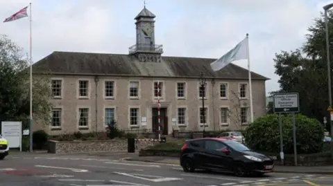 Chris Allen / Geograph Kendal County Hall, a grey stone building.