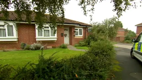 BBC Police outside a bungalow on Elizabeth Road, in Fleckney, Leicestershire