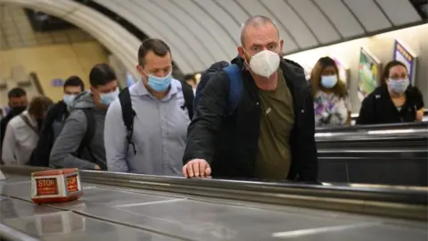 Getty Images Commuters on the Tube wearing a face covering