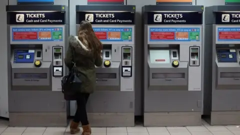 Getty Images Woman buying train ticket