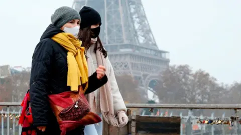 Getty Images People walk past Eiffel Tower