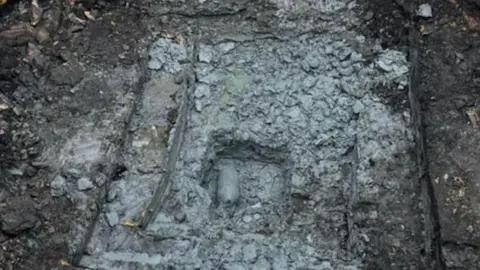 Essex Police The WW2 bomb in the centre of the image. It is covered in concrete where it was found on a construction site. 