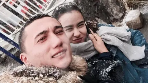 Sadam Abudusalamu Sadam Abudusalamu and Nadila Wumaier pose for a selfie in the snow in China